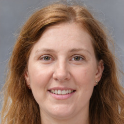 Joyful white adult female with long  brown hair and grey eyes