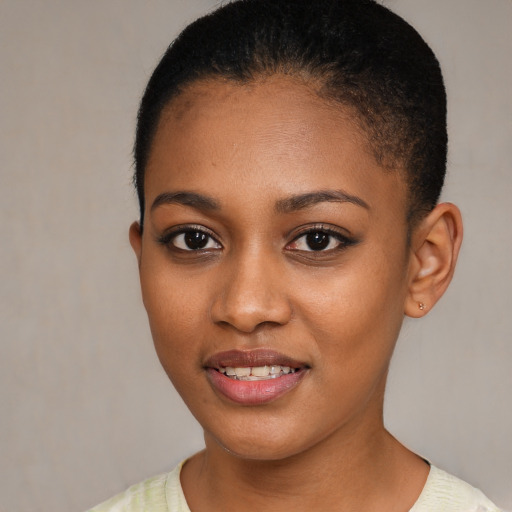 Joyful black young-adult female with short  brown hair and brown eyes