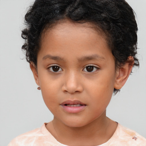 Joyful white child female with short  brown hair and brown eyes