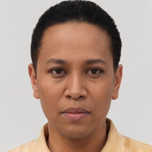 Joyful latino young-adult female with short  black hair and brown eyes