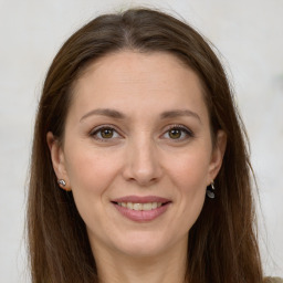 Joyful white adult female with long  brown hair and grey eyes