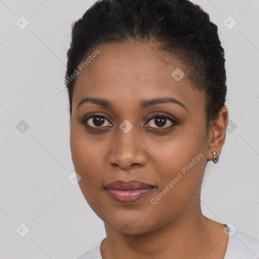 Joyful black young-adult female with short  brown hair and brown eyes