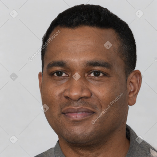 Joyful black young-adult male with short  black hair and brown eyes