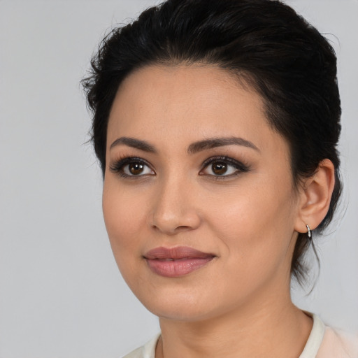 Joyful latino young-adult female with medium  black hair and brown eyes