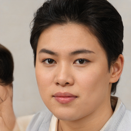 Joyful asian young-adult female with medium  brown hair and brown eyes