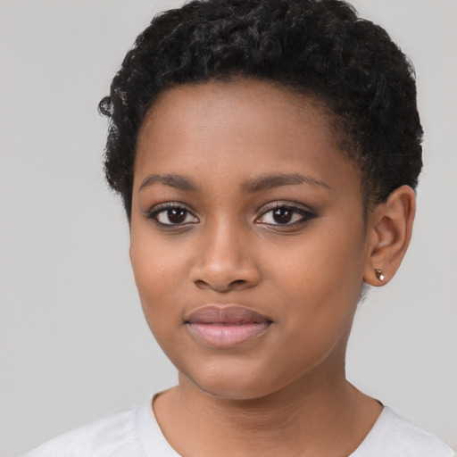 Joyful black young-adult female with short  brown hair and brown eyes