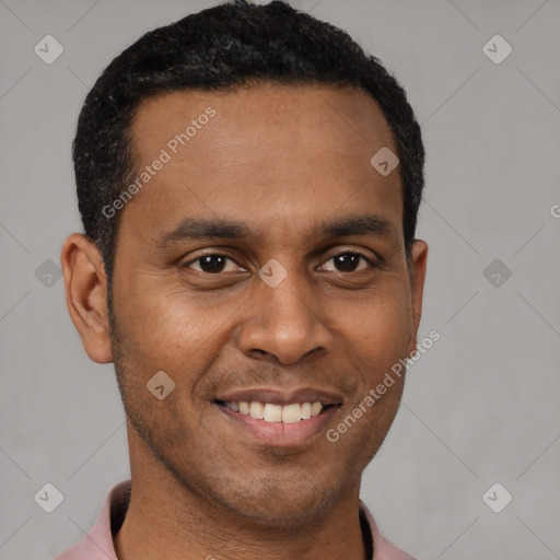 Joyful latino young-adult male with short  black hair and brown eyes