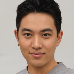 Joyful asian young-adult male with short  brown hair and brown eyes