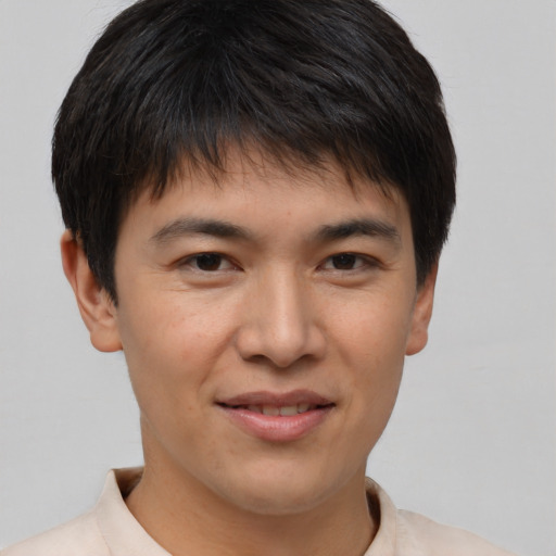 Joyful asian young-adult male with short  brown hair and brown eyes