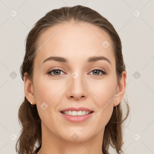 Joyful white young-adult female with medium  brown hair and grey eyes