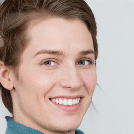 Joyful white young-adult female with short  brown hair and blue eyes