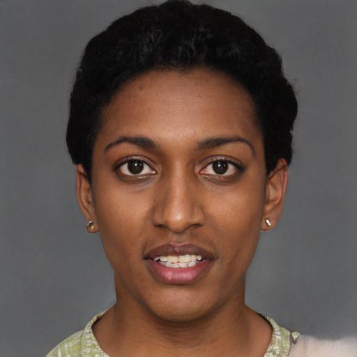 Joyful black young-adult female with short  black hair and brown eyes
