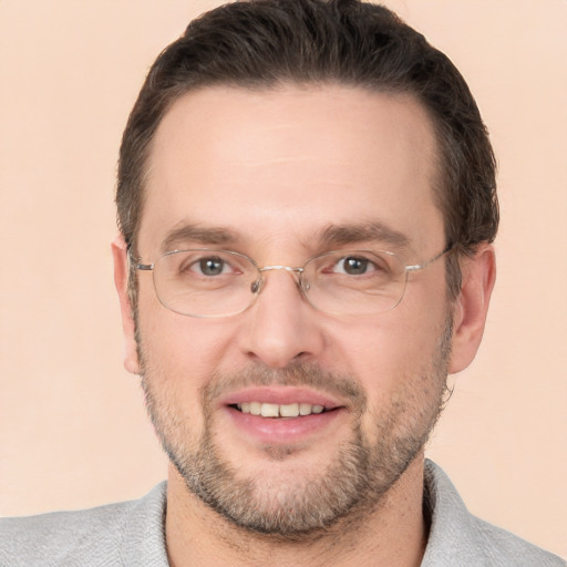 Joyful white adult male with short  brown hair and brown eyes