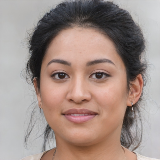 Joyful latino young-adult female with medium  brown hair and brown eyes