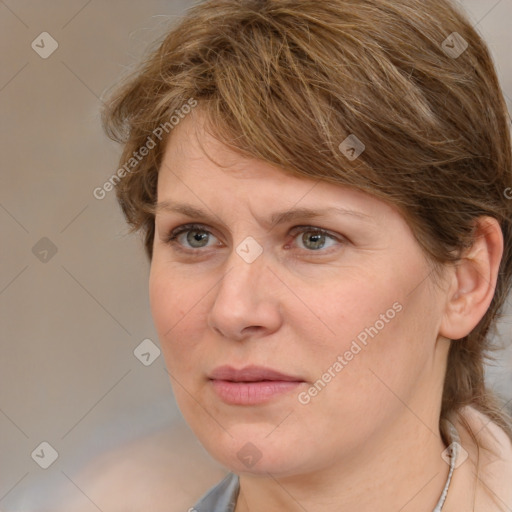 Joyful white adult female with medium  brown hair and blue eyes