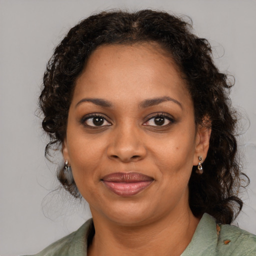Joyful black young-adult female with medium  brown hair and brown eyes