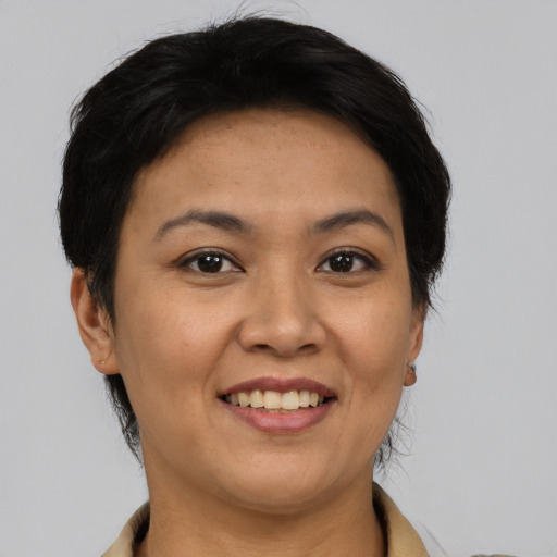 Joyful asian young-adult female with short  black hair and brown eyes