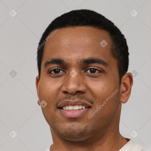 Joyful black young-adult male with short  black hair and brown eyes