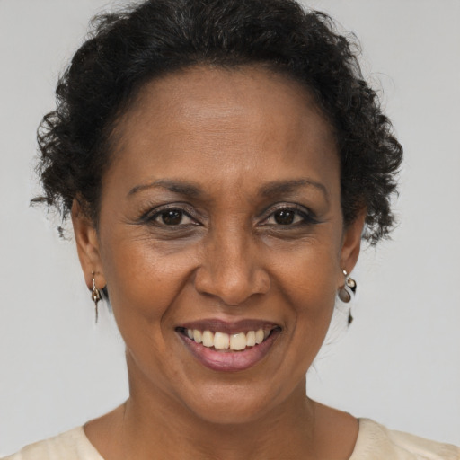 Joyful black adult female with short  brown hair and brown eyes