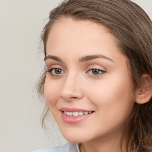 Joyful white young-adult female with medium  brown hair and green eyes