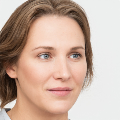 Joyful white young-adult female with medium  brown hair and blue eyes