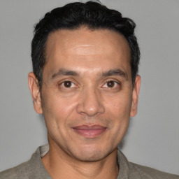 Joyful white adult male with short  black hair and brown eyes