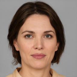 Joyful white adult female with medium  brown hair and brown eyes