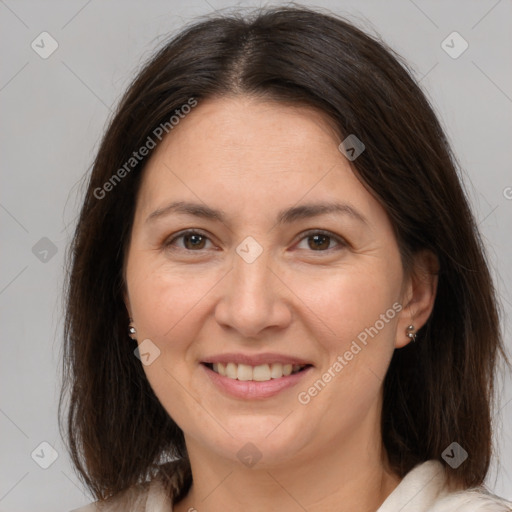 Joyful white adult female with medium  brown hair and brown eyes