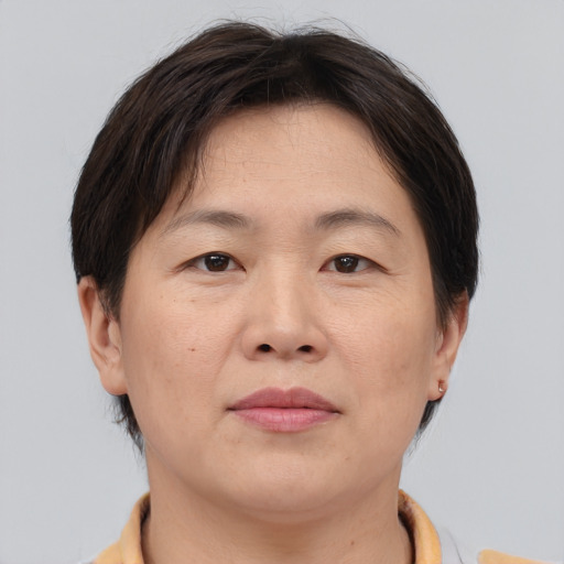 Neutral asian adult female with short  brown hair and brown eyes