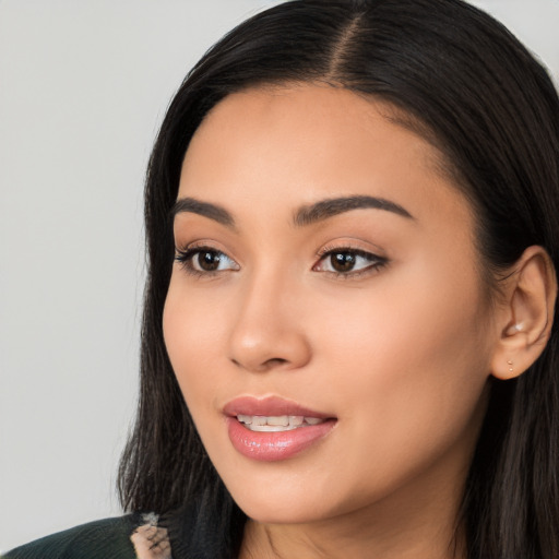 Joyful latino young-adult female with long  black hair and brown eyes