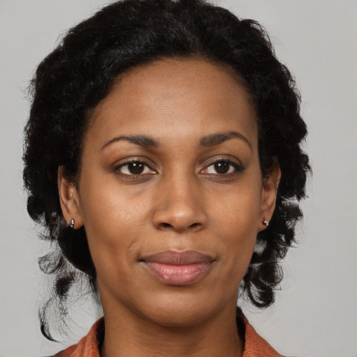 Joyful black young-adult female with medium  black hair and brown eyes