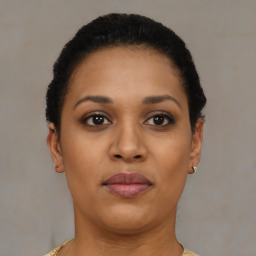 Joyful black young-adult female with short  brown hair and brown eyes