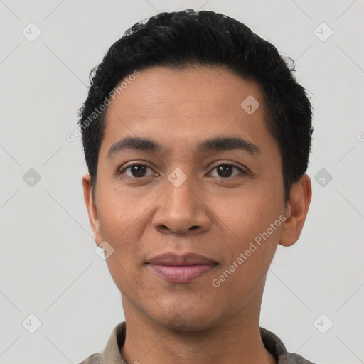 Joyful latino young-adult male with short  black hair and brown eyes