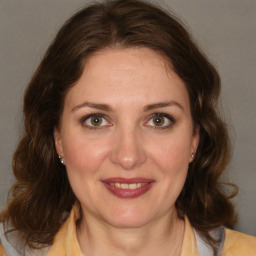 Joyful white adult female with medium  brown hair and brown eyes