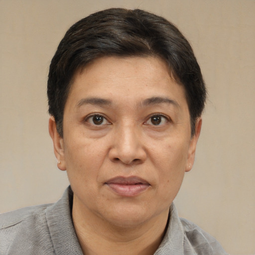 Joyful asian adult female with short  brown hair and brown eyes