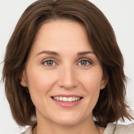 Joyful white young-adult female with medium  brown hair and green eyes