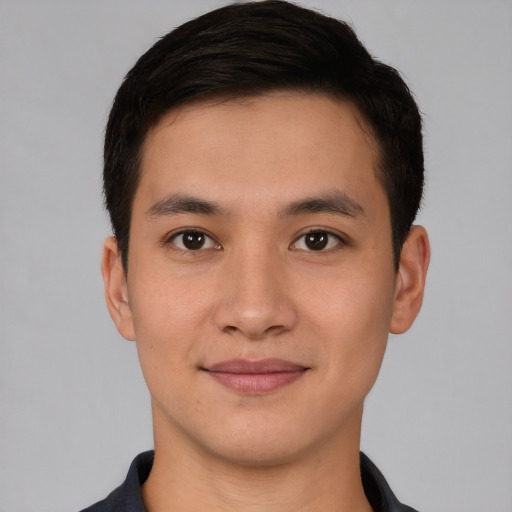 Joyful asian young-adult male with short  brown hair and brown eyes