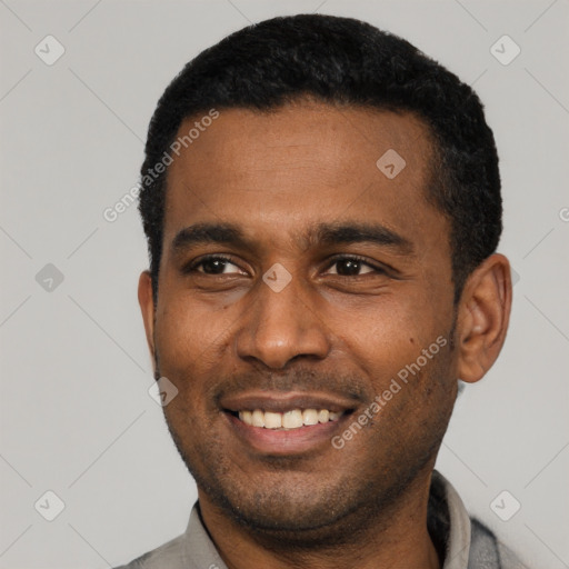 Joyful black young-adult male with short  black hair and brown eyes