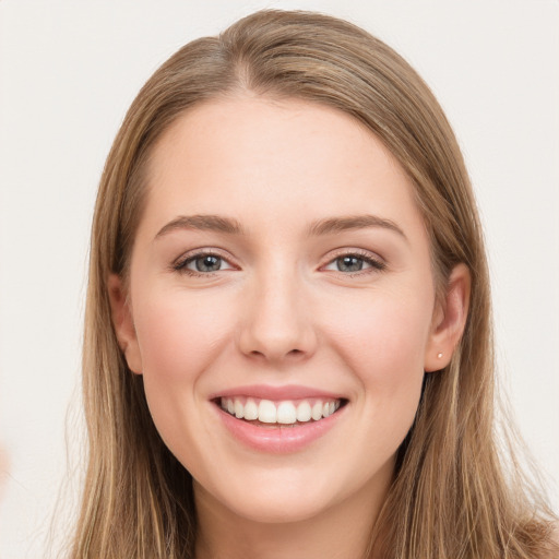 Joyful white young-adult female with long  brown hair and green eyes