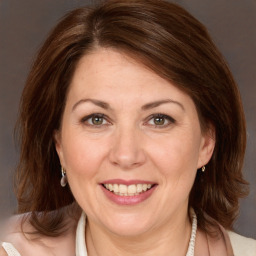 Joyful white adult female with medium  brown hair and brown eyes