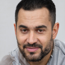 Joyful white adult male with short  brown hair and brown eyes