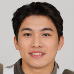 Joyful asian young-adult male with short  brown hair and brown eyes