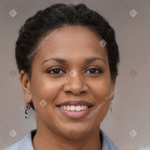 Joyful black adult female with short  brown hair and brown eyes