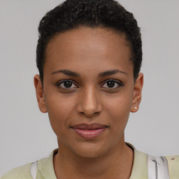 Joyful black young-adult female with short  brown hair and brown eyes