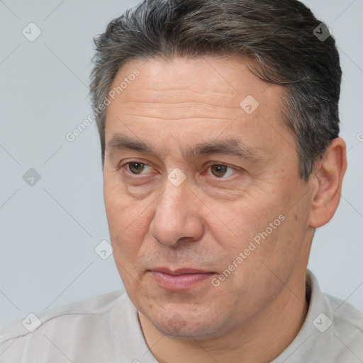 Joyful white adult male with short  brown hair and brown eyes