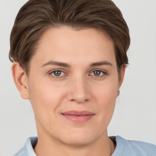 Joyful white young-adult female with short  brown hair and grey eyes