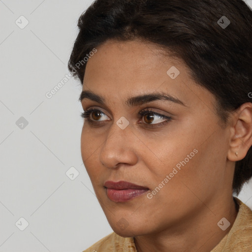 Joyful latino young-adult female with short  brown hair and brown eyes