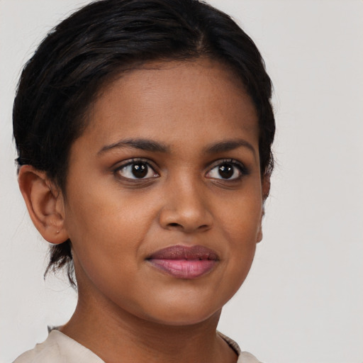 Joyful black young-adult female with short  brown hair and brown eyes