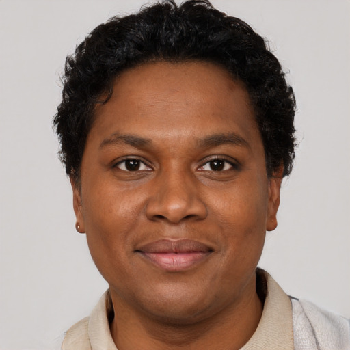 Joyful black young-adult male with short  brown hair and brown eyes