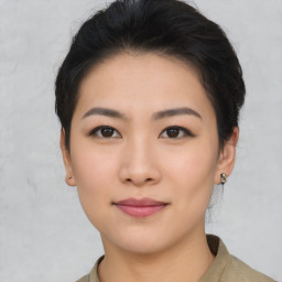 Joyful asian young-adult female with short  black hair and brown eyes